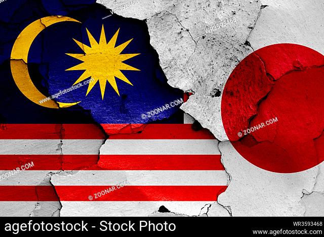 flags of Malaysia and Japan painted on cracked wall