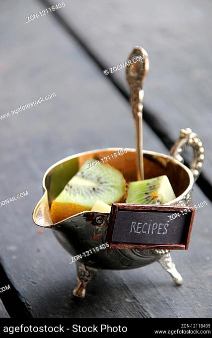 recipes concept, a silver bowl with kiwi and text