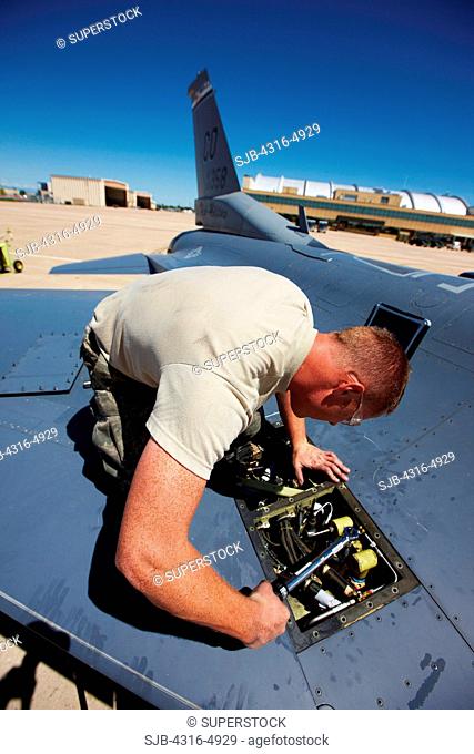 Technician working on an F-16 Fighting Falcon