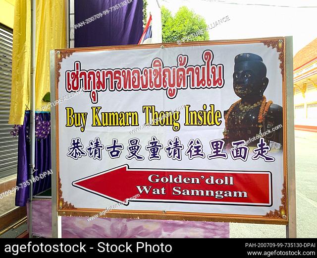 23 June 2020, Thailand, -: A sign in front of the Wat Samngam temple points the visitors to a Kuman Thong figure, which is said to contain ashes with human...