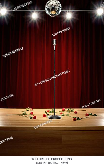 Microphone amongst roses on stage