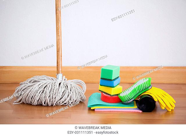 Mop and cleaning equipment on wooden floor