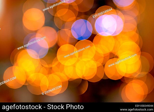 Background overlay of a soft defocused bokeh of a colourful lights on a Christmas tree