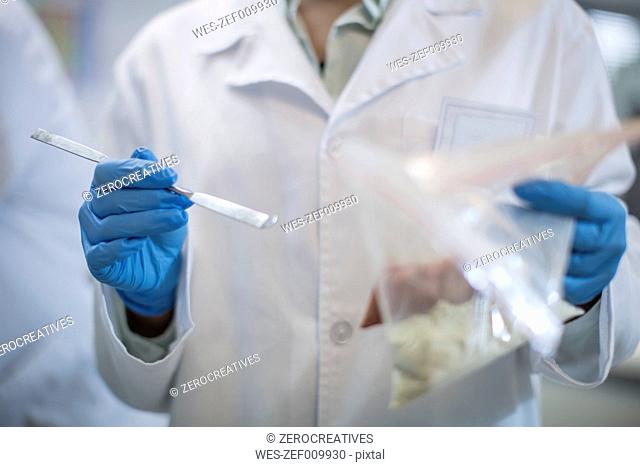 Scientist working in lab wearing latex gloves