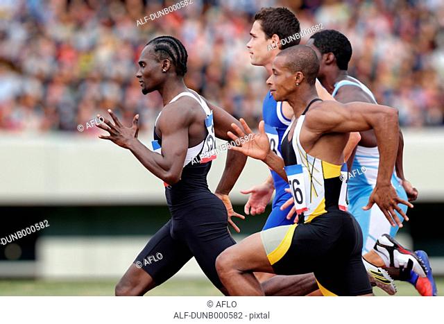 Athletes running on running track