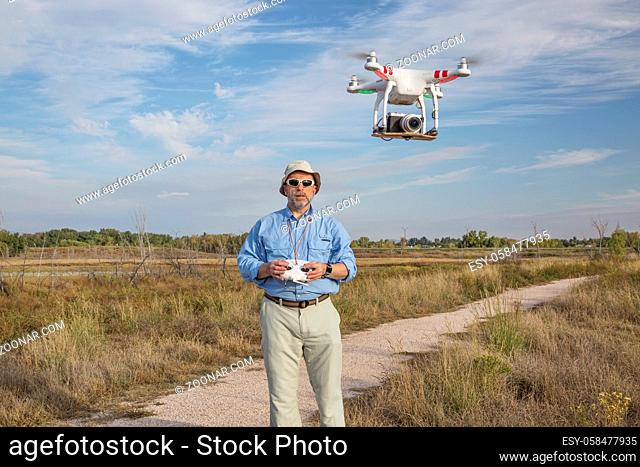 FORT COLLINS, CO, SEPTEMBER 28, 2014: Photogrpaher, Marek Uliasz, is launching the DJI Phantom 2 quadcopter drone with Panasonic Lumix GM1 camera on board