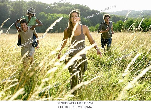 Friends running in a field