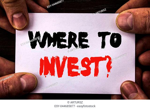 Conceptual hand writing text showing Where To Invest Question. Concept meaning Financial Income Investing Plan Advice Wealth written Sticky Note Paper Holding...