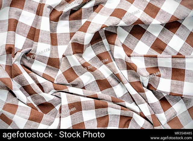 Creasy white and brown checked cotton fabric closeup