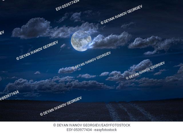 Moon and clouds in the night. Moonlight and road background. Dark blue backdrop