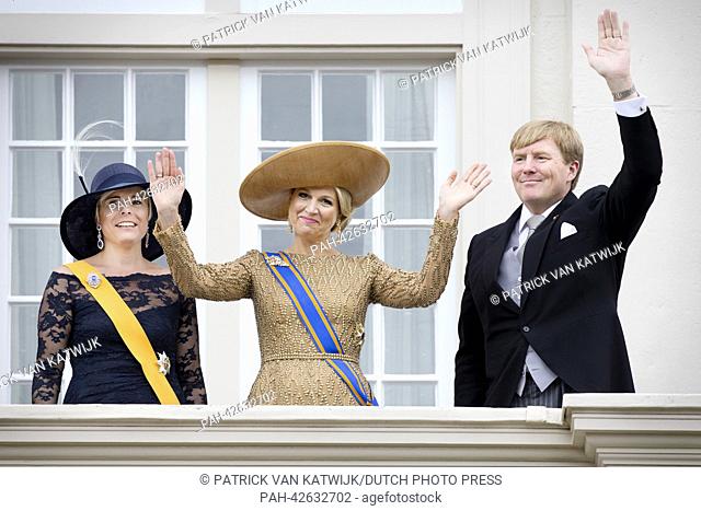 Dutch King Willem-Alexander, Queen Maxima (C) and Princess Laurentien wave to the crowd from the balcony of the Palace Noordeinde in The Hague, The Netherlands
