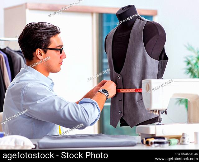 The young man tailor working on new clothing