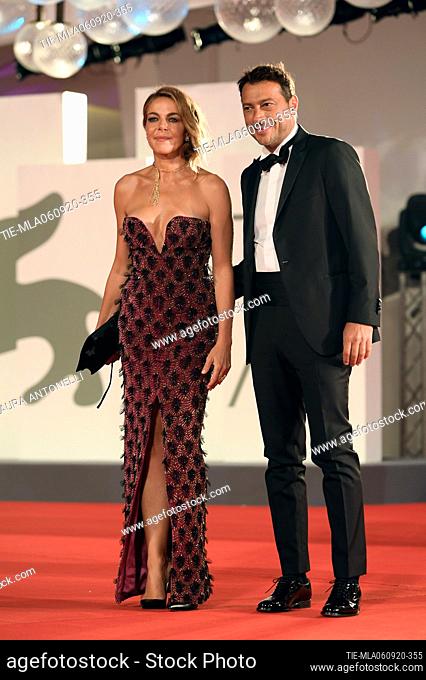 Claudia Gerini, Simon Clementi walks the red carpet ahead of the movie ""Filming Italy best movie award"" at the 77th Venice Film Festival on September 06