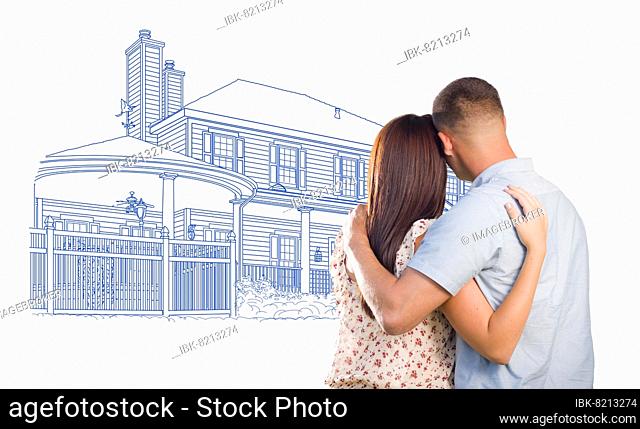 Embracing military couple looking at house drawing on white