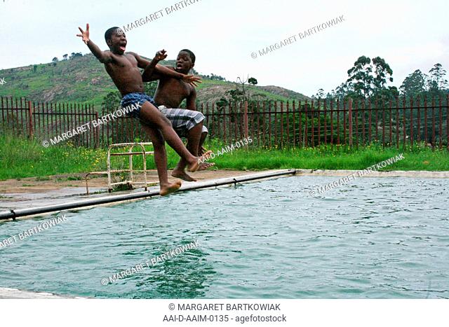 School boys jumping into swimming pool, St Mark's School, Mbabane, Hhohho, Kingdom of Swaziland