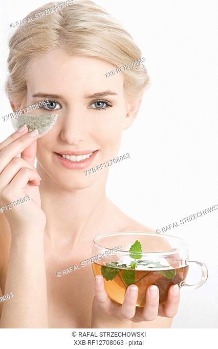 woman with teabags under eye