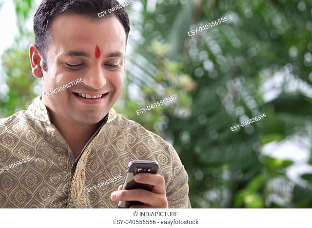 Man reading an sms on a mobile phone
