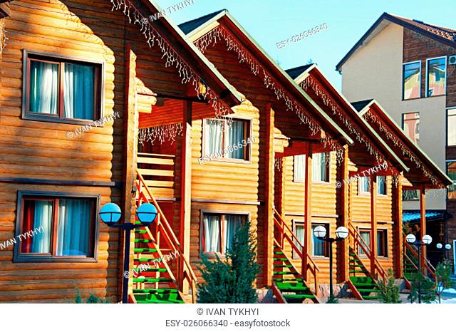 Row of a wooden houses at ski resort in the sunshine day