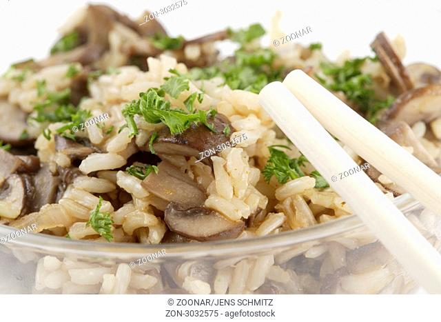 Reisgericht, mit braunen Champignons und Petersilie in Glasschale, mit Essstäbchen