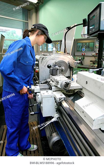 female apprentice working with machines