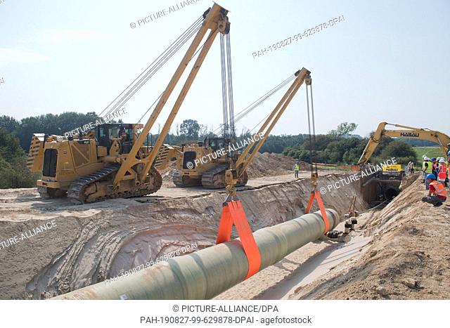 27 August 2019, Mecklenburg-Western Pomerania, Groß Polzin: A section of the Eugal natural gas pipeline (European Gas Link Pipeline) is being laid in the Peene...