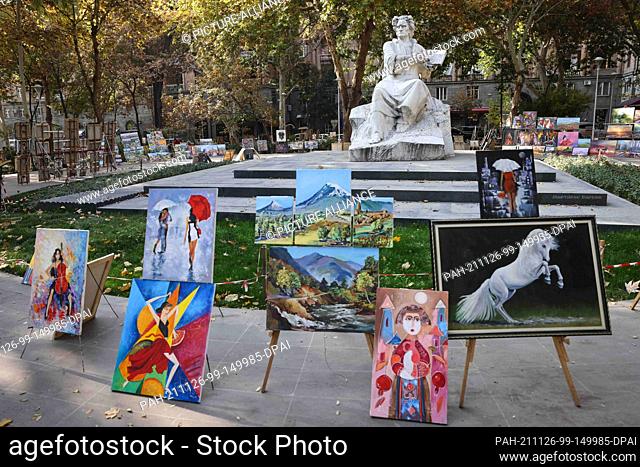 14 November 2021, Armenia, Jerewan: In a small park next to a sculpture depicting the Armenian painter Martiros Saryan (1880-1972), artists offer their work