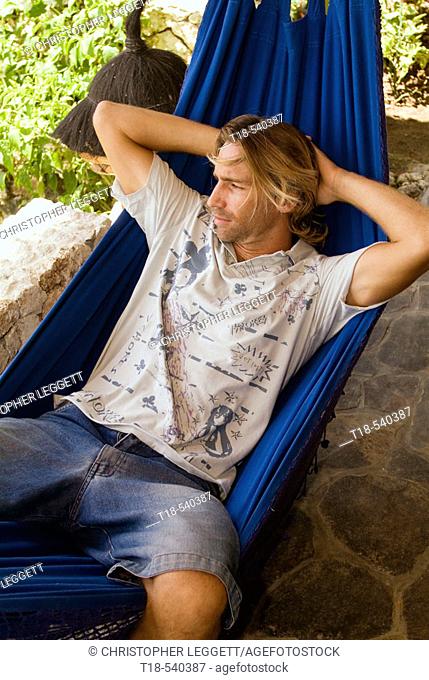 young man relaxing on hammock