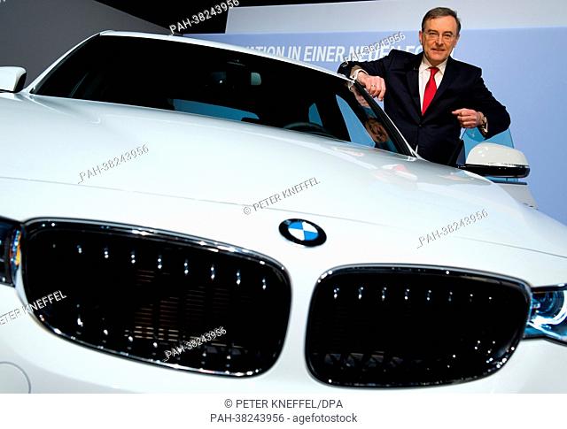 CEO of BMW Group, Norbert Reithofer, poses for the camera with a BMW 3 Gran Turismo at a press briefing on annual results of the automobile manufacturing...