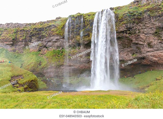 World famous Seljalandsfoss, a majestic waterfall in southern Iceland, coming down over a cliff, fed by a glacier