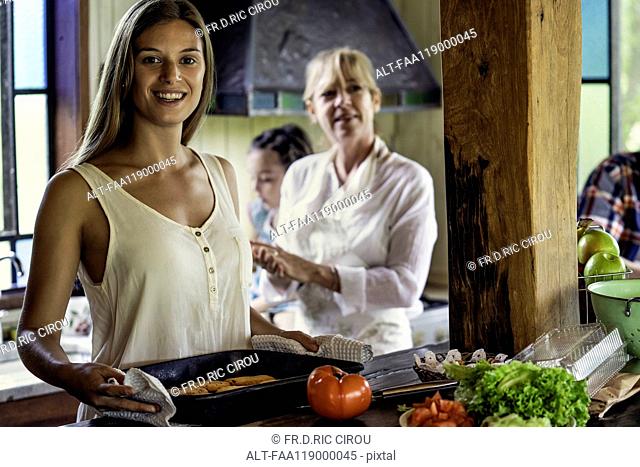 Woman with her parents standing in kitchen