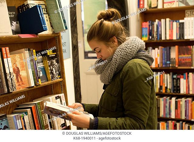 Teenage girl, 17, in City Lights Bookstore, North Beach, San Francisco, California, USA
