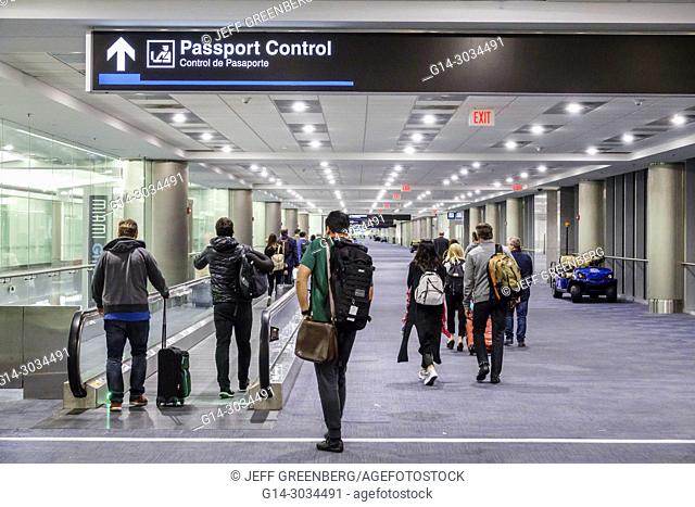 Florida, Miami, Miami International Airport MIA, Passport Control concourse, arriving passengers, man, woman, moving walkway, interior