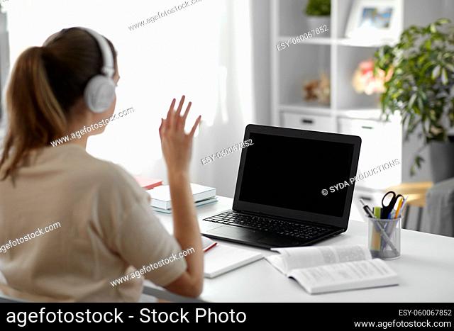 student with laptop having video call at home