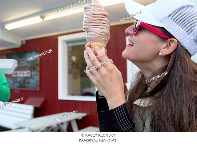 Hiker enjoying ice cream cone at cafe, Lake Blanco, Washington, USA