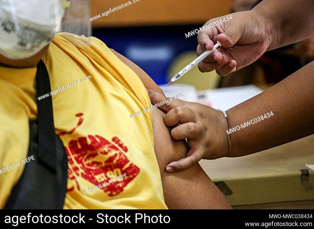 A medical worker receives a dose of Sinovac vaccine at the Batasan Hills National High School. Manila, Philippines