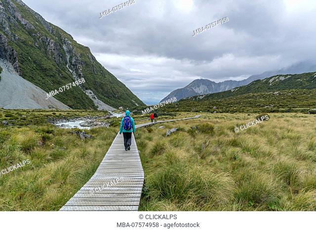 Hiker walking on Hooker Valley Track, Mount Cook National Park, Mackenzie district, Canterbury region, South Island, New Zealand