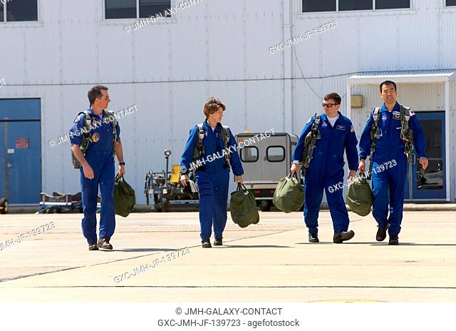 The STS-114 crewmembers walk to the nearby flight line of the T-38 trainer jets at Ellington Field near Johnson Space Center (JSC)