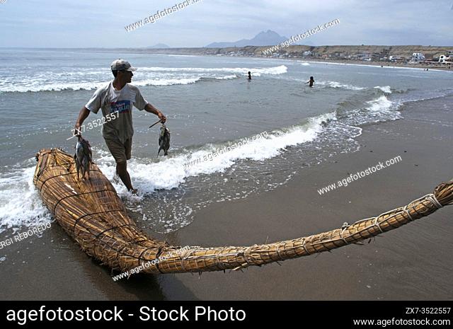 Fishers in Huanchaco beach, Caballitos de Totora, Reed Boats, near Trujillo city, La Libertad, Peru