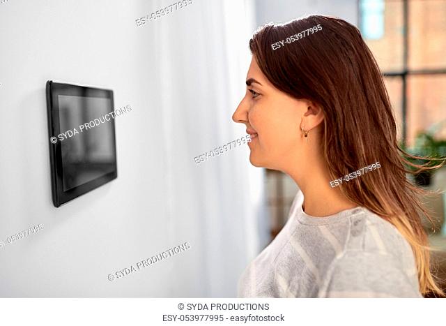 woman looking at tablet computer at smart home