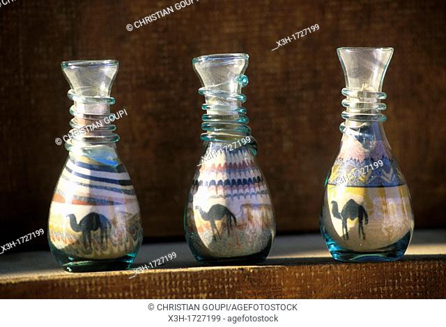 bottles filled with colored sands forming decorative motive, Jordan, Middle East, Asia