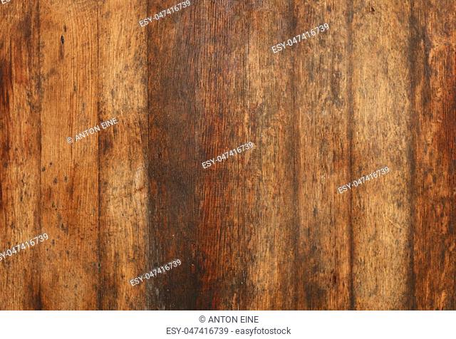 Vintage brown barrel wooden planks background texture with scratches and black stains over wood grain of old aged oak barrel bottom, close up