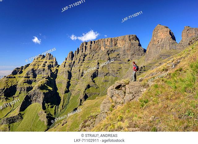 Woman hiking in front of Sterkhorn, Cathkin Peak and Monks Cowl, Grays Pass, Monks Cowl, Mdedelelo Wilderness Area, Drakensberg, uKhahlamba-Drakensberg Park