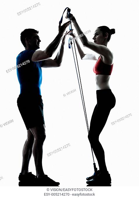 personal trainer man coach and woman exercising gymstick silhouette studio isolated on white background