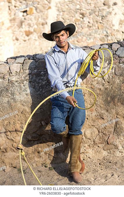 A Mexican charro or cowboy practices roping skills on his horse before a Charreada competition at a hacienda ranch in Alcocer, Mexico