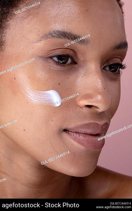 Studio shot of woman with cream on face