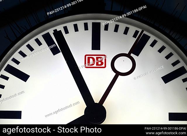 14 December 2023, Brandenburg, Potsdam: The word ""DB"" is written on the face of a large clock above a platform. Photo: Soeren Stache/dpa