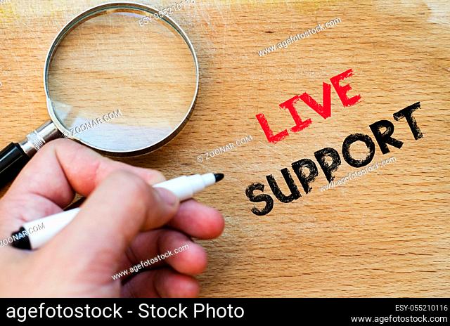 Live support text concept with human hand over wooden background
