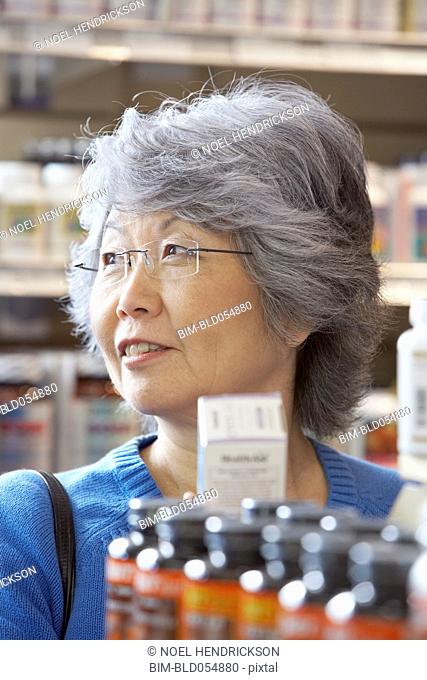 Senior Asian woman shopping for vitamins