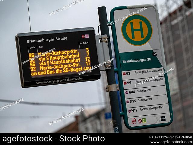 24 November 2021, Brandenburg, Potsdam: Notices about the current 3G rule are displayed on an electronic board at a tram stop in the city center