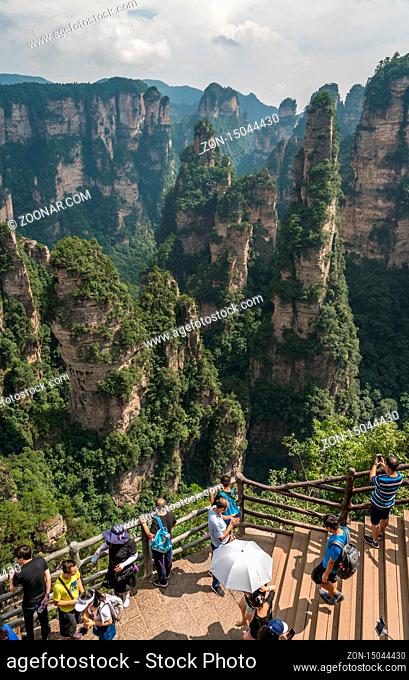 Zhangjiajie, China - August 2019 : Tourists taking pictures on mobile phones on the Enchanting terrace viewpoint, Avatar mountains nature park